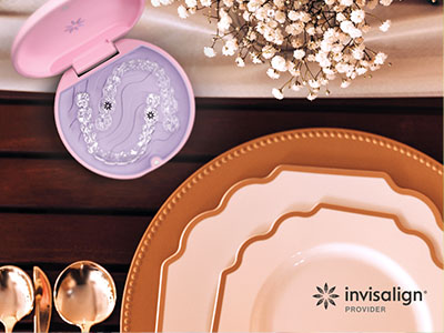 The image showcases a collection of tableware, including plates and bowls, displayed on a wooden surface with a pink box and a spoon in the background.